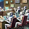 Illustrasjon generert av OpenAI-programmet Dall-E, ut frå desse stikkorda: Rembrandt oil painting robots writing text newspapers books journalists students office.