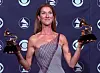 Celine Dion holds her Grammies for record of the year and best female pop vocal performance backstage at the 41st Annual Grammy Awards at the Shrine Auditorium in Los Angeles, Wednesday, Feb. 24, 1999. Dion won for her work on 'My Heart Will Go On.' (AP Photo/Reed Saxon)