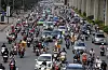 In this June 21, 2017, photo, motorbikes and cars fight for space on a street in Hanoi, Vietnam. VietnamÄôs motorbike taxis are seeing their business dry up as customers increasingly opt for ride hailing services like Uber and Grab-Taxi. (AP Photo/Tran Van Minh)
