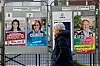 A woman walks past campaign posters during the second round of the French mayoral election in Paris, France, March 22, 2026. REUTERS/Benoit Tessier TPX IMAGES OF THE DAY